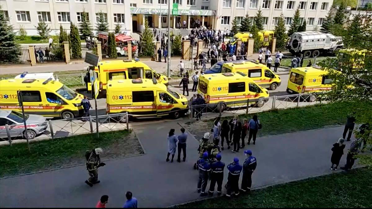 In this image taken from video, an ambulance and police trucks are parked at a school after a s ...