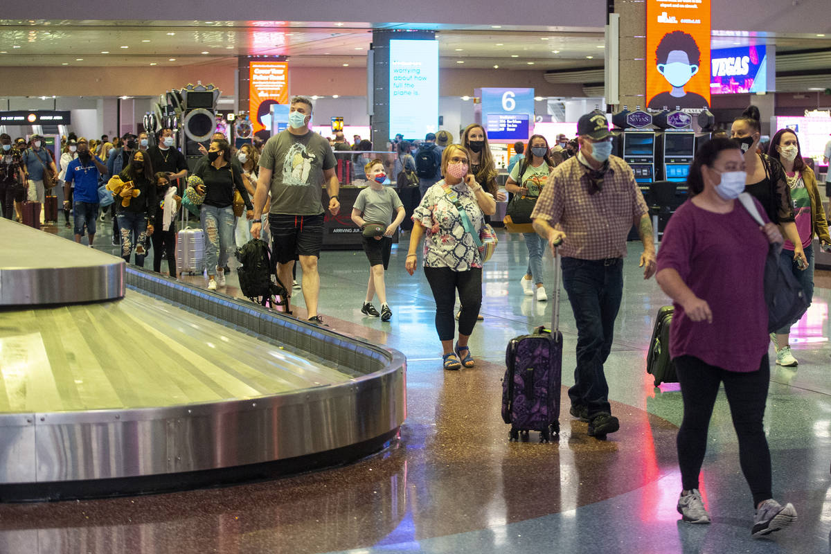 Travelers arrive to McCarran International Airport Terminal 1 in Las Vegas, Thursday, May 13, 2 ...