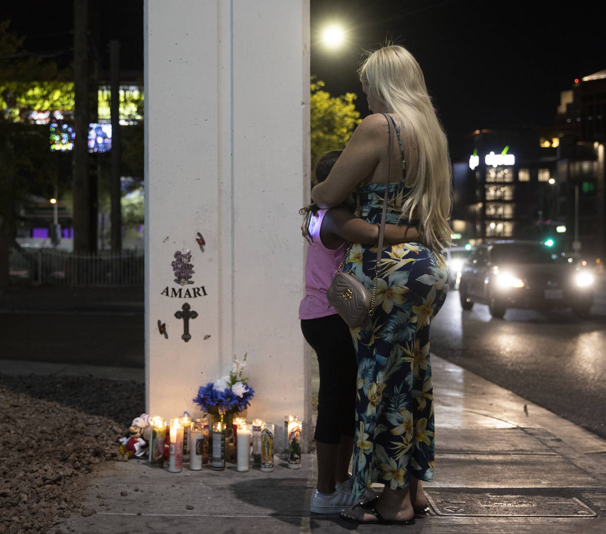 Rachelle Anthony, right, and daughter JaÕLea hug next to a memorial for Amari Nicholson ou ...