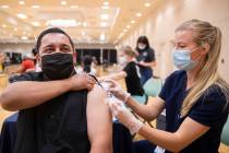 Jose Padilla, left, get's his COVID-19 vaccination from Touro University Nevada physician assis ...