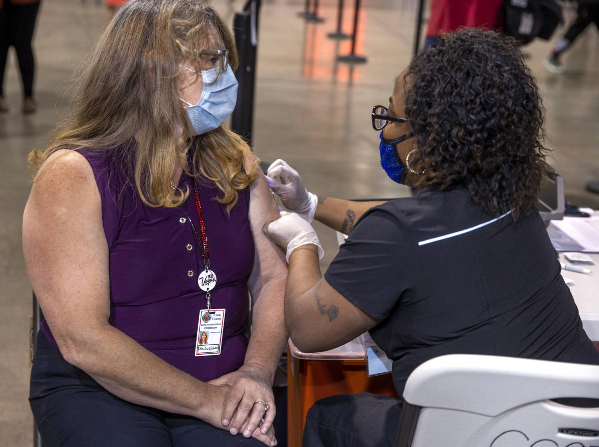 Commissioner Marilyn Kirkpatrick, left, receives her second vaccine dose from Impact health's N ...