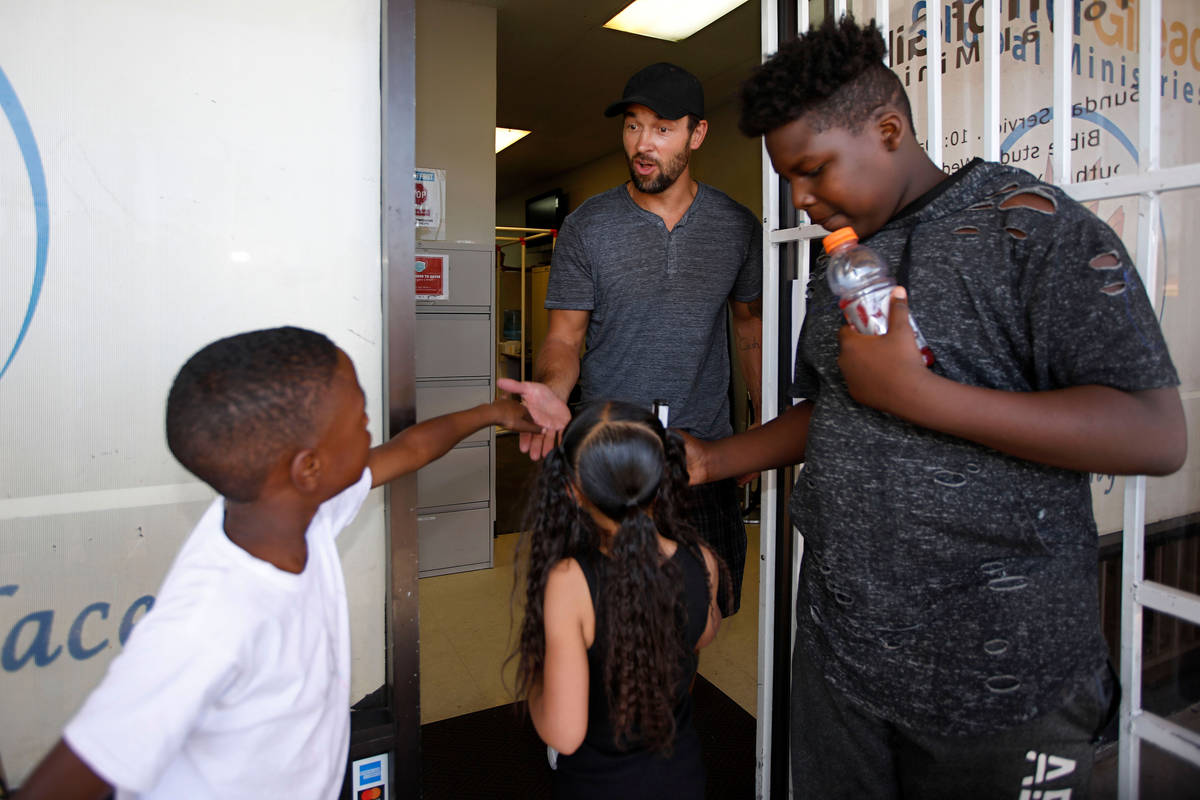 Former Golden Knights player Deryk Engelland, center, greets Korey Brooks, 8, from left, Jaydeo ...