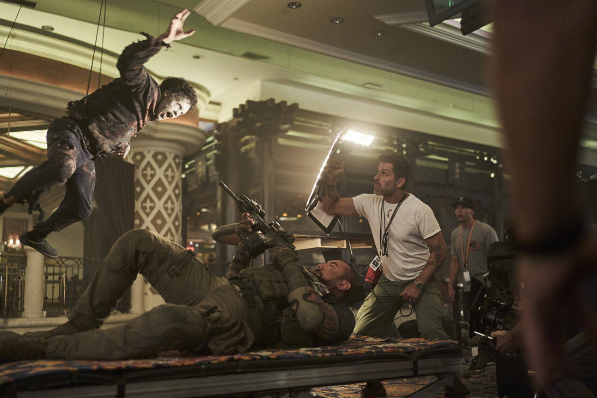 Actor Dave Bautista and director Zack Snyder are shown on the set of "Army of the Dead." (Clay ...