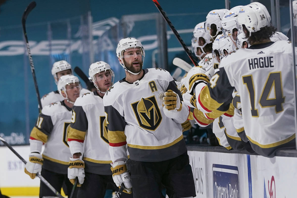 Vegas Golden Knights defenseman Alex Pietrangelo, middle, is congratulated by teammates after s ...