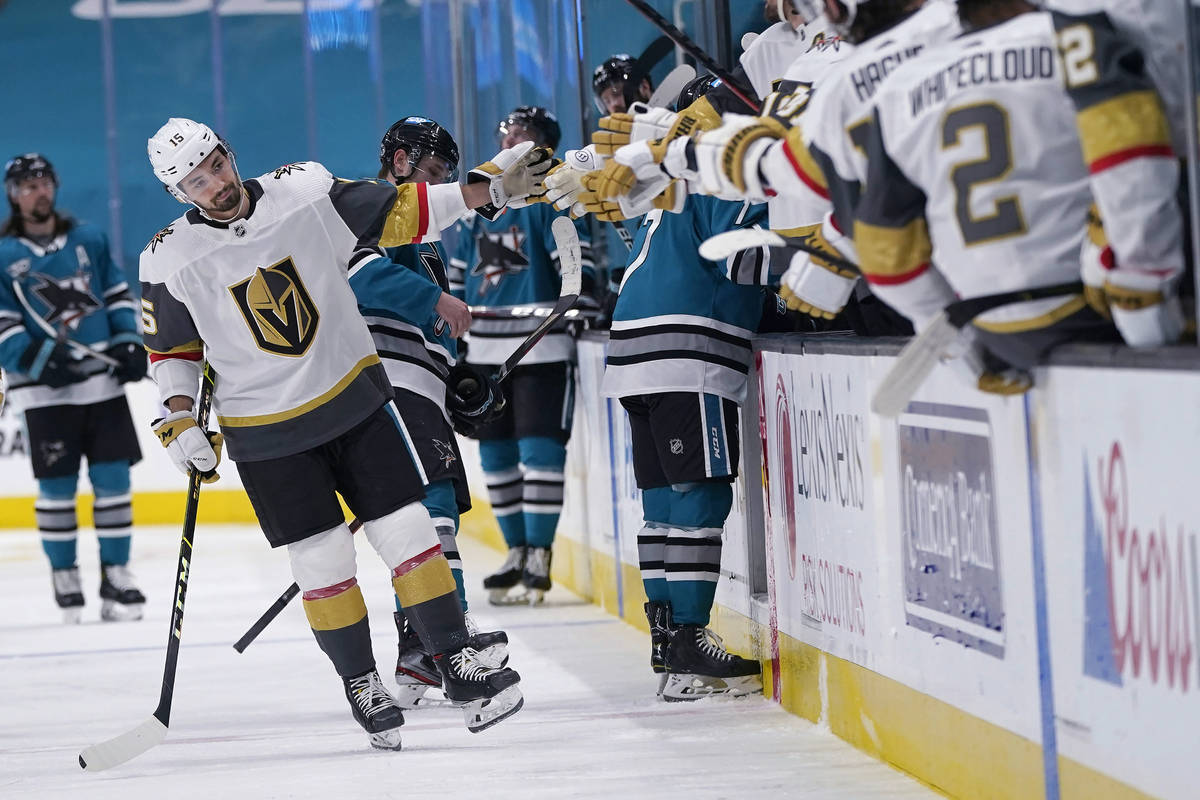 Vegas Golden Knights right wing Dylan Sikura, left, is congratulated by teammates after scoring ...
