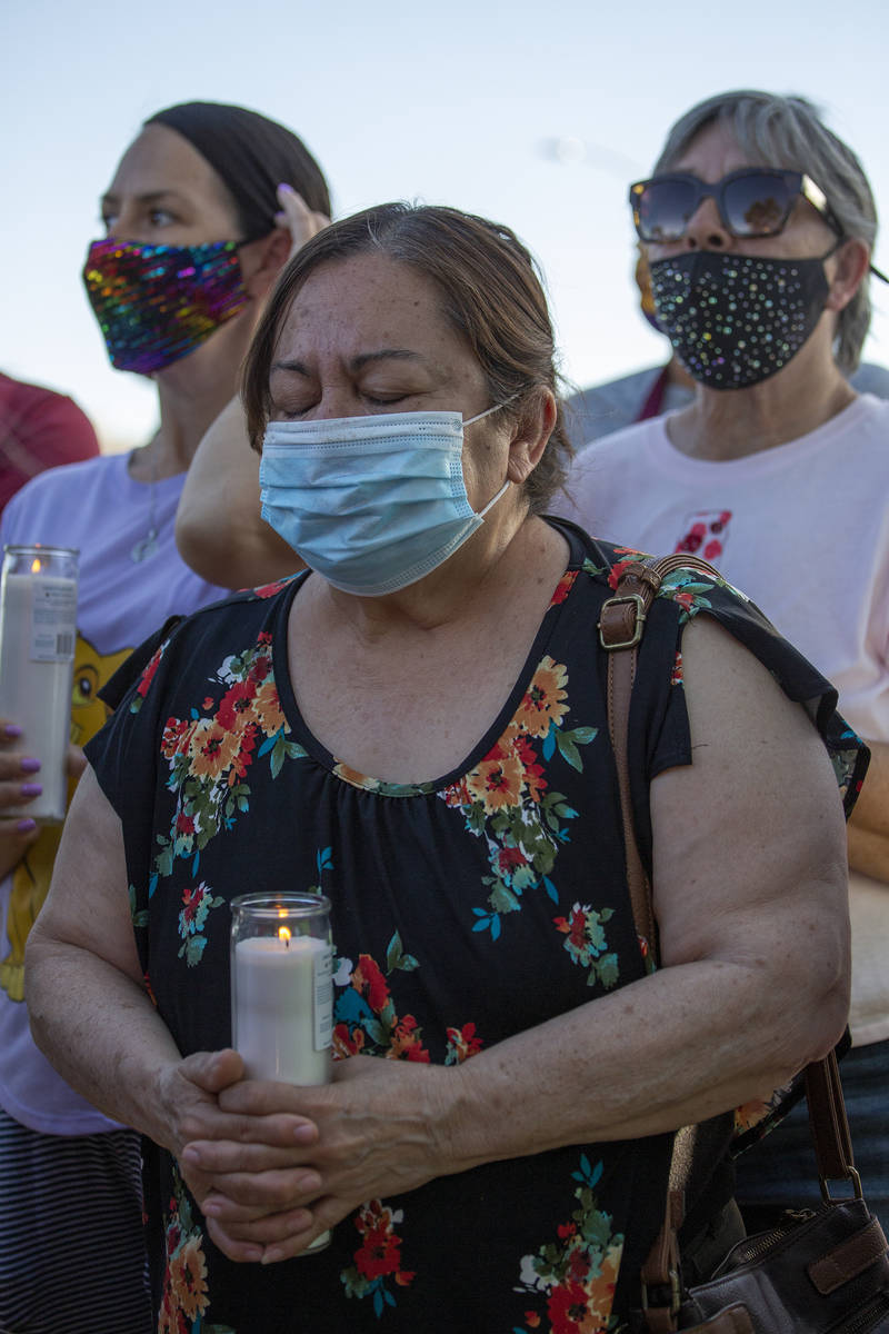 Maria Zapata prays during a vigil for 2-year-old Amari Nicholson, whose mother's boyfriend was ...