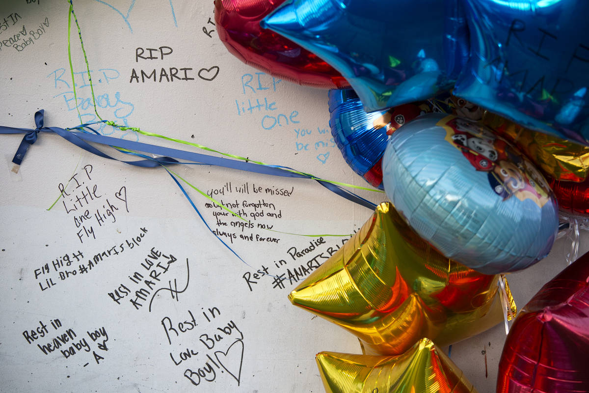 Mourners wrote notes on a pillar outside the Emerald Suites where 2-year-old Amari Nicholson's ...