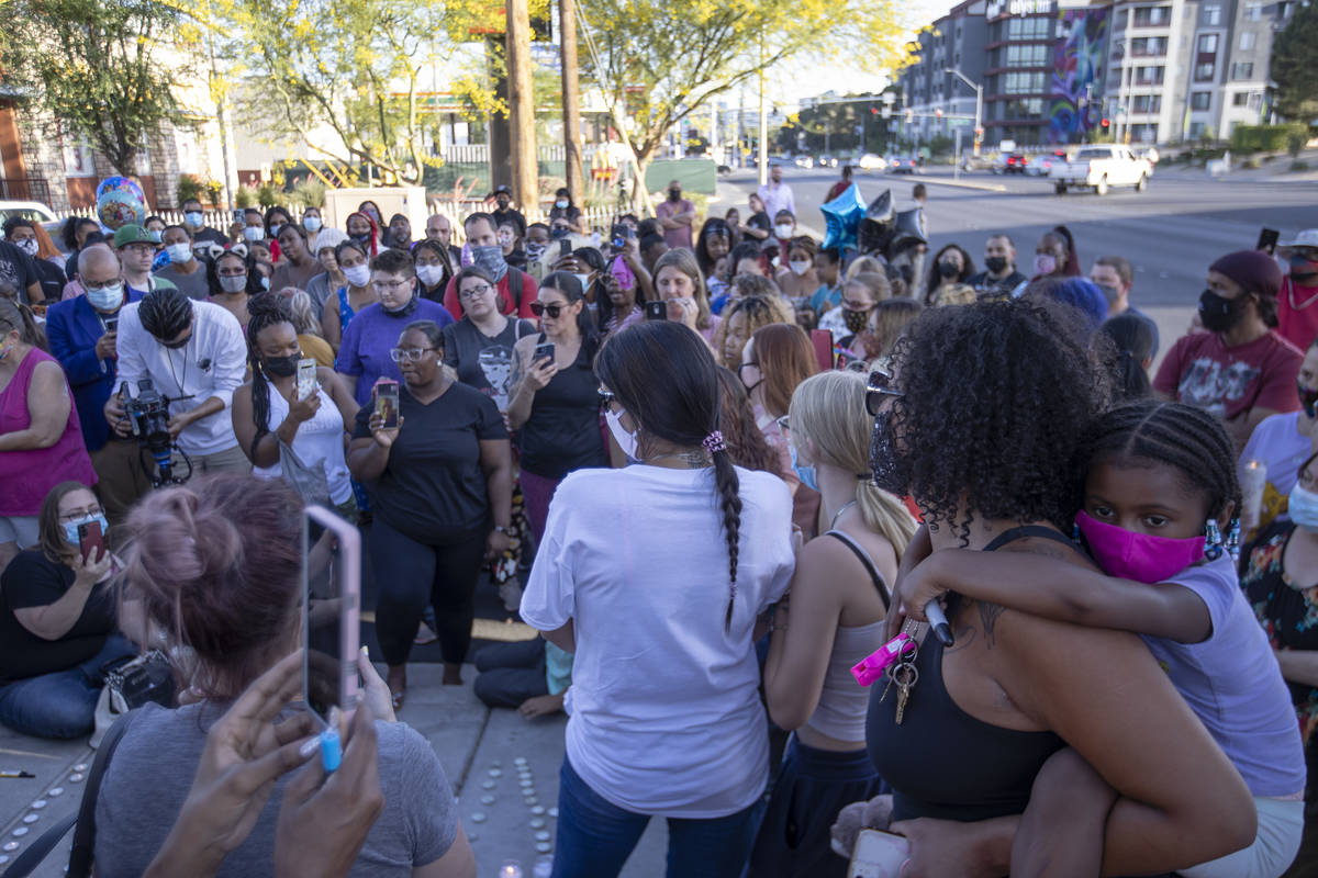 Many gather to mourn 2-year-old Amari Nicholson outside the Emerald Suites near where the toddl ...