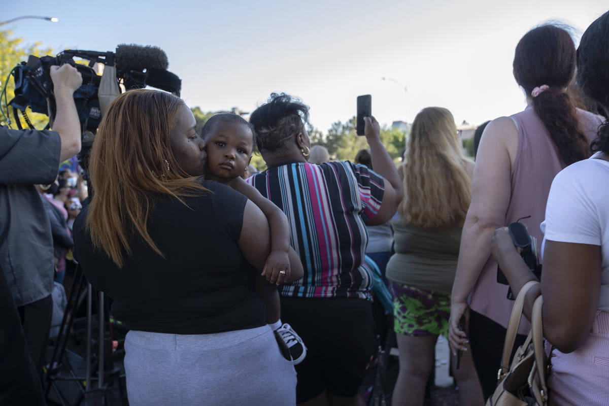 Marquette Kirkwood kisses her son Taren Allen, 1, during a vigil for 2-year-old Amari Nicholson ...