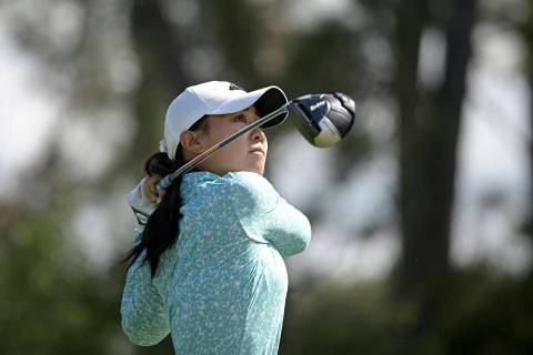Danielle Kang watches after hitting her tee shot on the seventh hole during the final round of ...