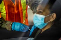 Nevada National Guard PFC Alicia Vavona gives an injection during a preview of the new drive-th ...