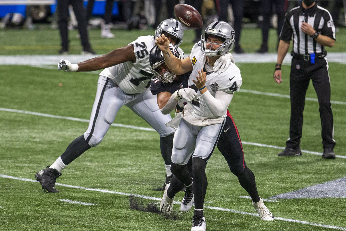 Atlanta Falcons defensive tackle Jacob Tuioti-Mariner (91) forces a fumble as Las Vegas Raiders ...