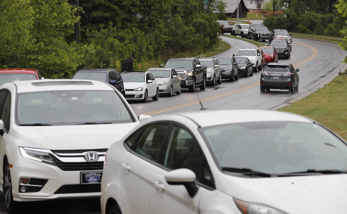 Cars line up on Pine Plaza Drive for gas at the Costco in Apex, N.C., Wednesday, May 12, 2021. ...
