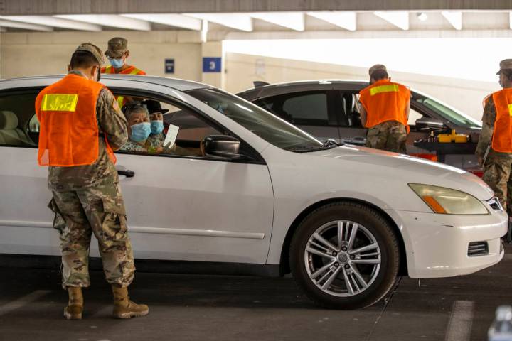 Nevada National Guardsmen begin to give injections during a preview of the new drive-through CO ...