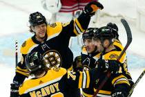 Boston Bruins right wing David Pastrnak (88), defenseman Charlie McAvoy (73), and center Brad M ...