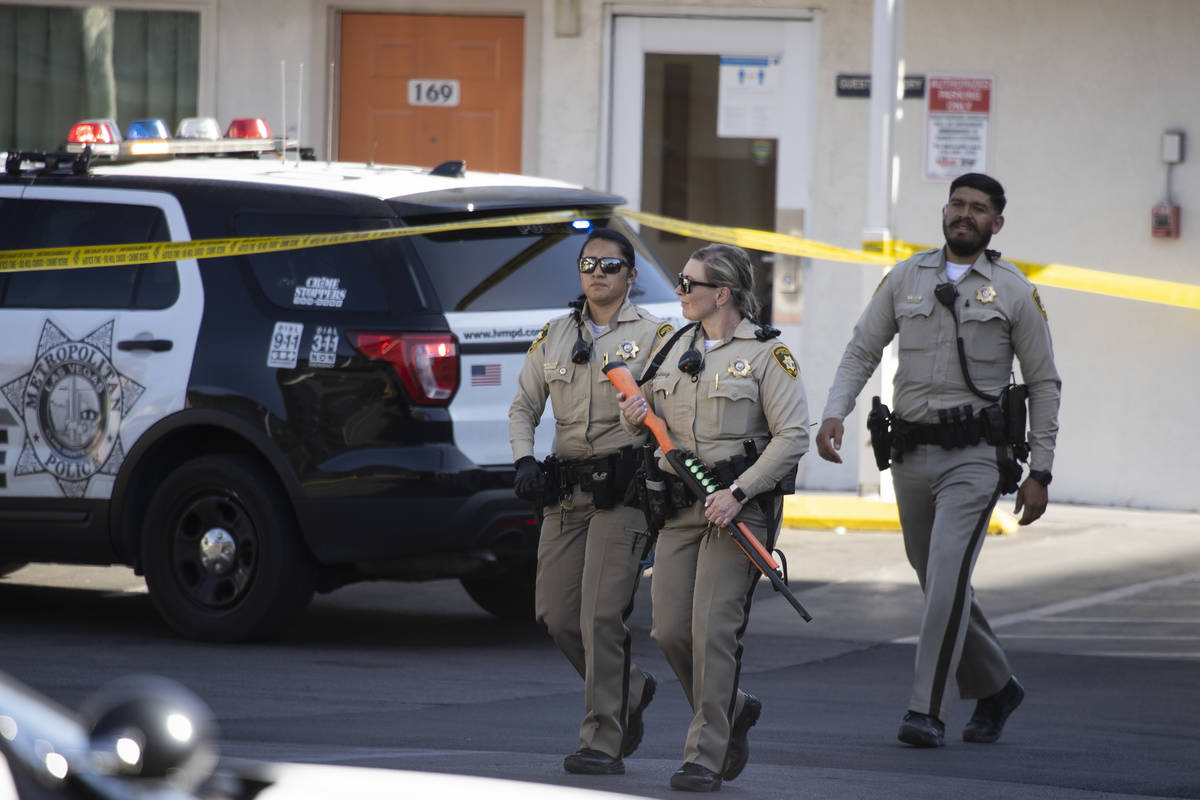 Police investigate the scene of a homicide at the Motel 6 near Koval Lane and Tropicana Avenue ...