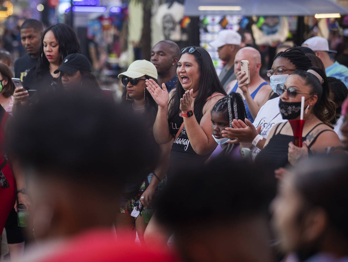 Maskless people walk through the Fremont Street Experience on Thursday, May 13, 2021, in Las Ve ...