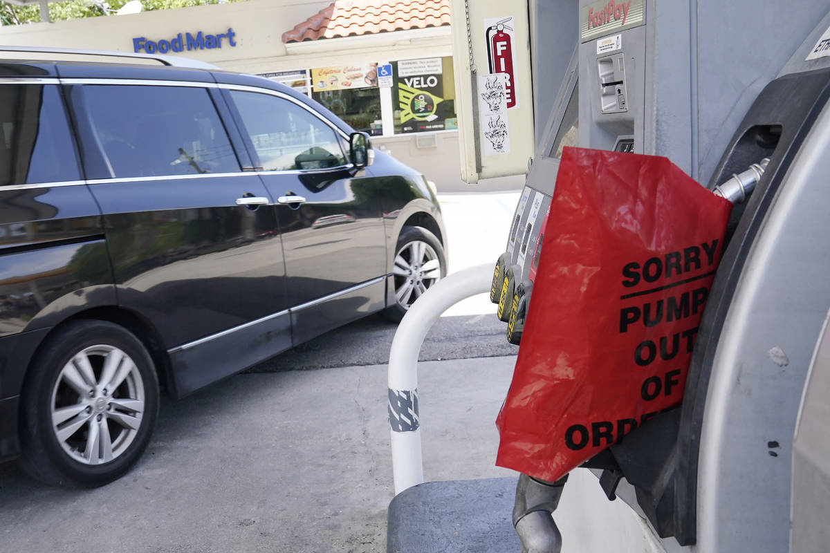 A customer drives from a Chevron station after it ran out of gasoline, Wednesday, May 12, 2021, ...