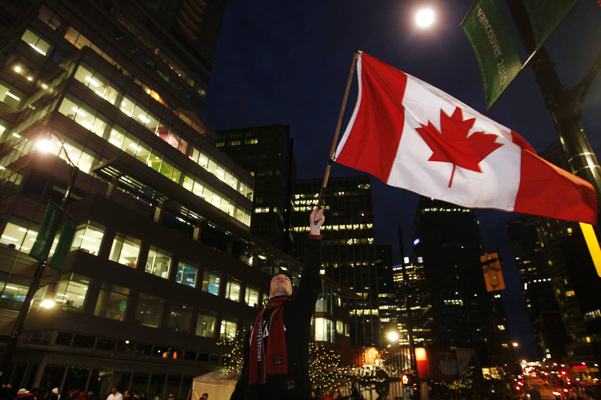 A Canadian fan celebrates their victory against the United States in the final hockey match at ...