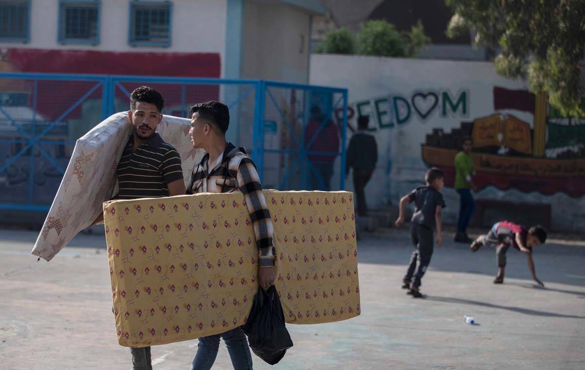 Palestinians take shelter provided by the U.N. at a school after fleeing their homes from the o ...