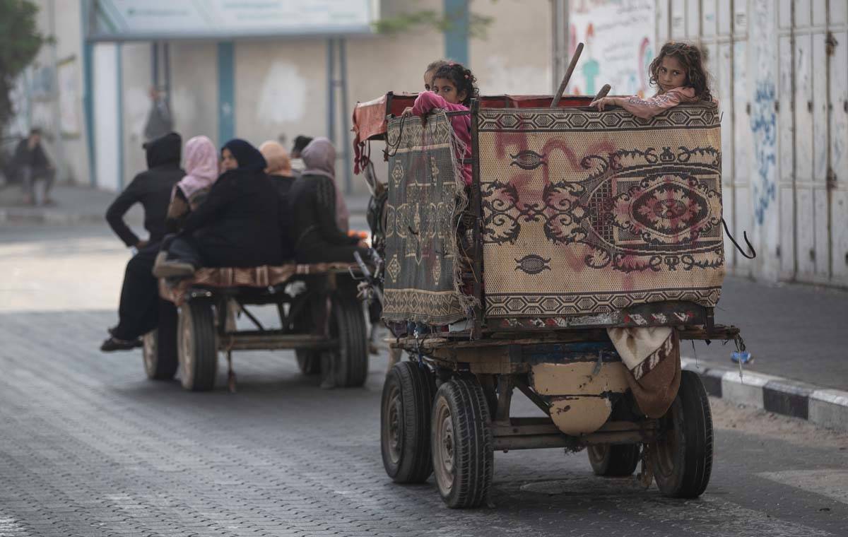 Palestinians flee their homes after overnight Israeli heavy missile strikes on their neighborho ...