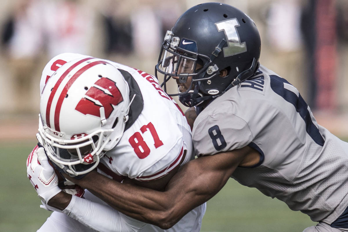 In this Oct.19, 2019, file photo, Illinois defender Nate Hobbs (8) takes down Wisconsin's Quint ...