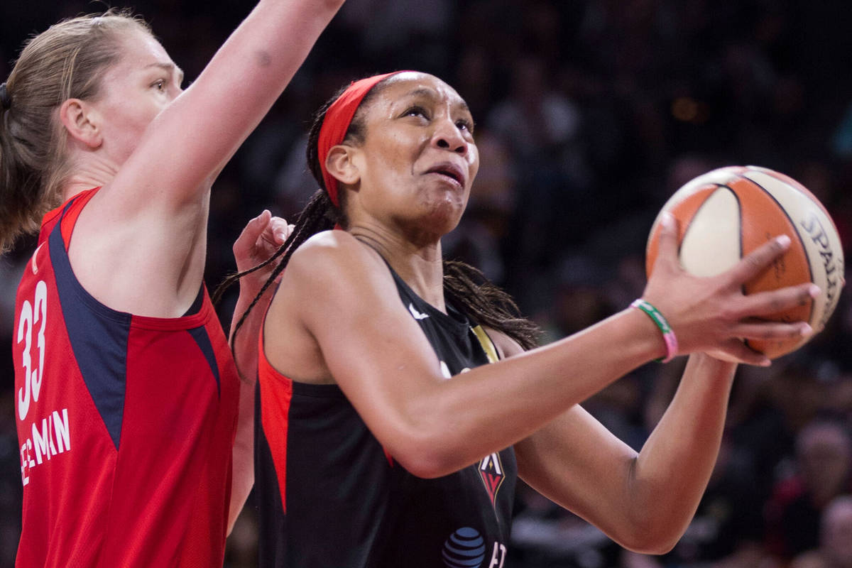 Las Vegas Aces center A'ja Wilson (22) drives past Washington Mystics center Emma Meesseman (33 ...