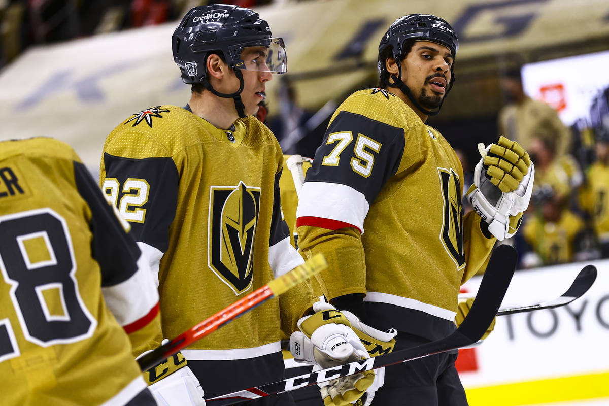 Golden Knights left wing Tomas Nosek (92) and Golden Knights right wing Ryan Reaves (75) look o ...