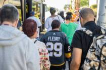 Elena Leger, middle, waits in line to board an RTC bus to Toshiba Plaza to watch the Vegas Gold ...