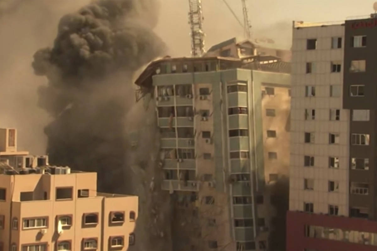 A building housing various international media, including The Associated Press, collapses after ...