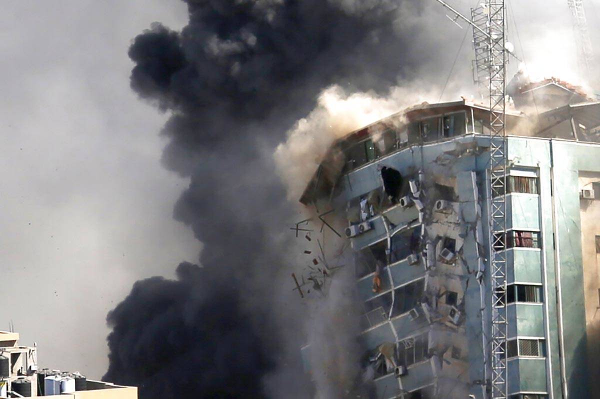 The building housing the offices of The Associated Press and other media in Gaza City collapses ...