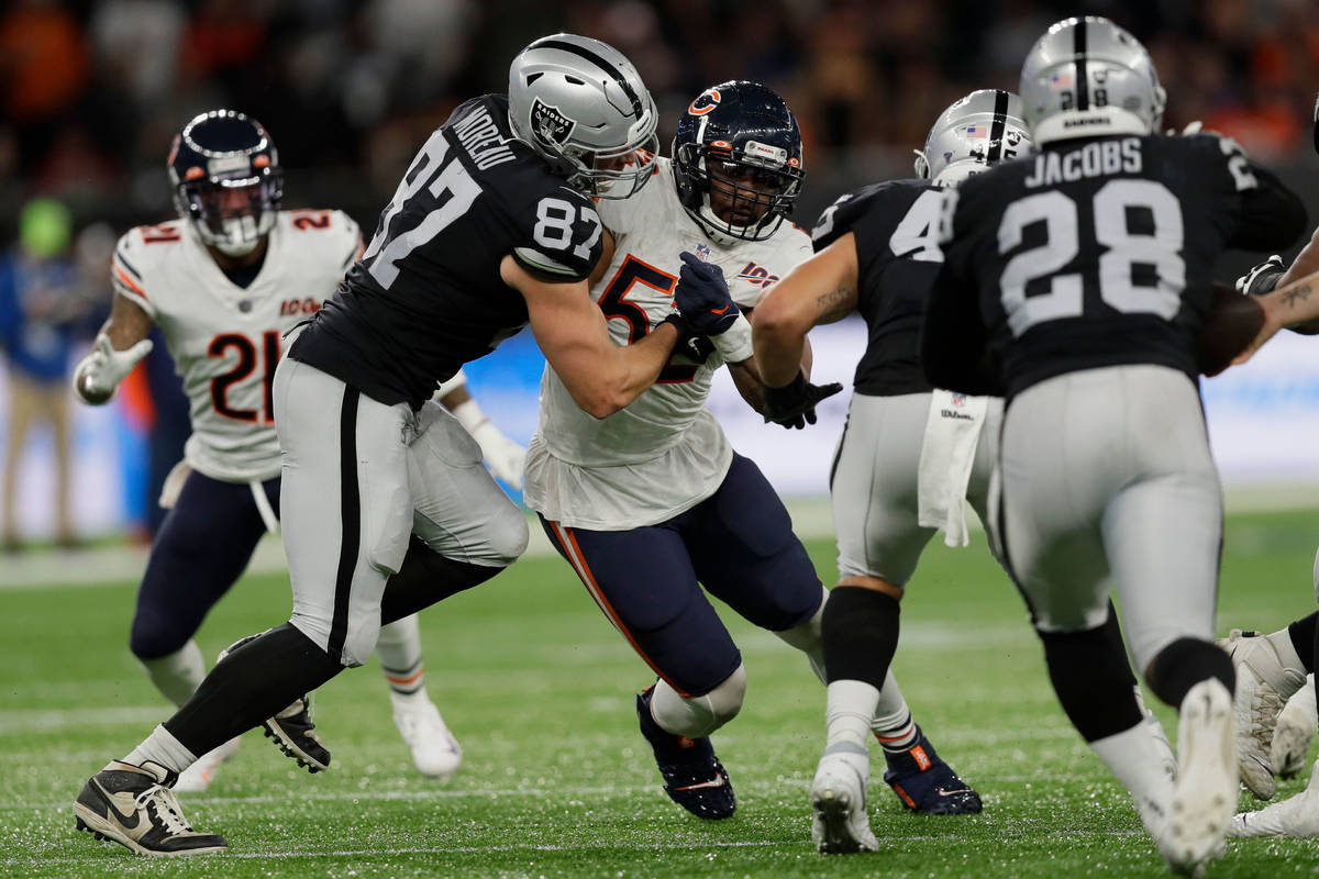 Chicago Bears outside linebacker Khalil Mack (52) is blocked by Raiders tight end Foster Moreau ...