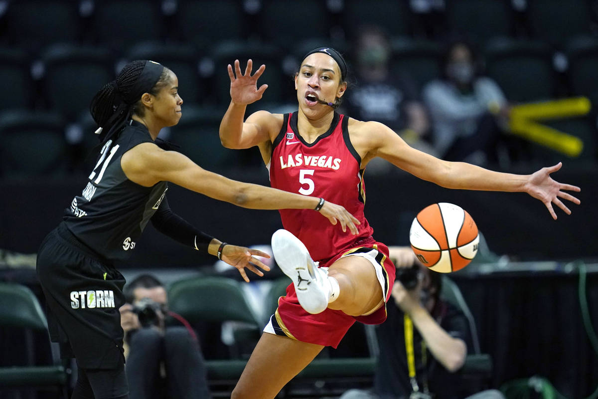 Las Vegas Aces' Dearica Hamby (5) defends against Seattle Storm's Jordin Canada in the first ha ...