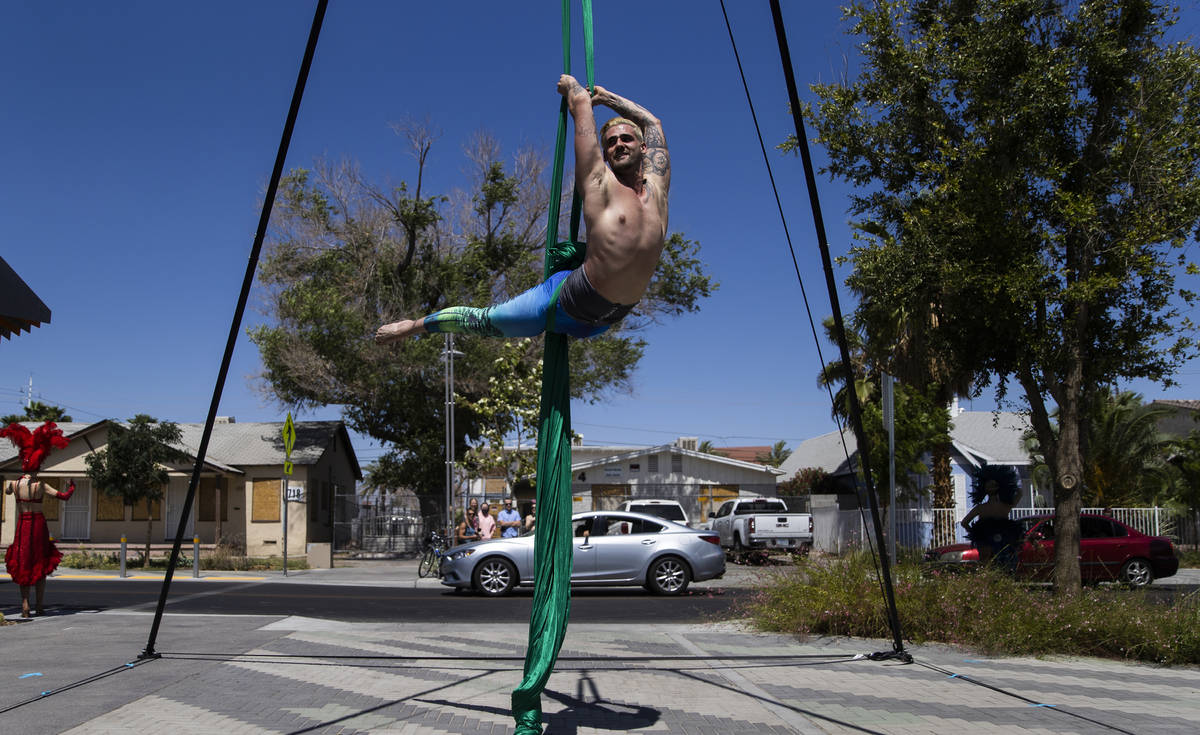 Aerial silks artist Derek McGinnis performs for passing cars during the Las Vegas Days Parade o ...