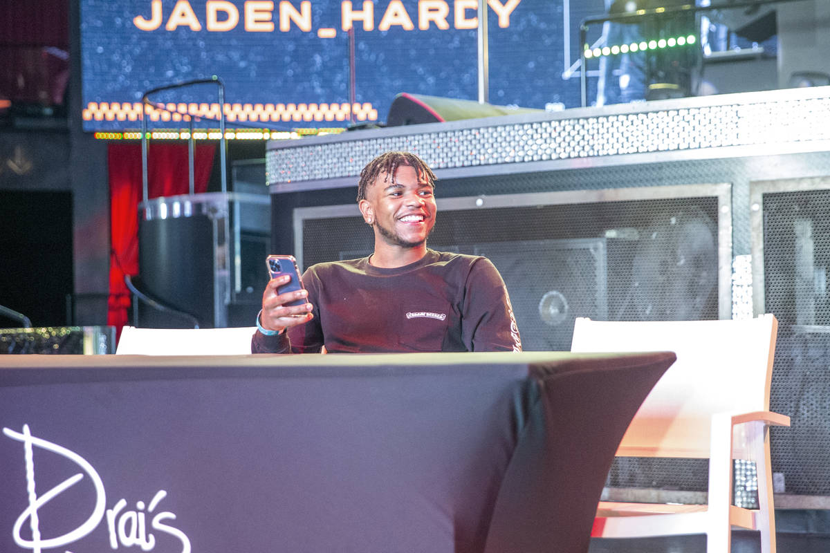 Jaden Hardy, a Coronado High School basketball prospect, streams on his phone at an event to an ...