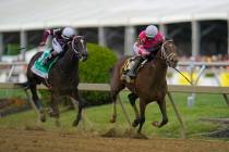 Flavien Prat atop Rombauer, right, breaks away from Irad Ortiz Jr. atop Midnight Bourbon moment ...
