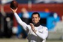 Raiders quarterback Derek Carr warms up before the start of an NFL football game against the De ...