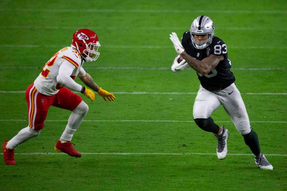 Las Vegas Raiders tight end Darren Waller (83) makes a catch as Kansas City Chiefs strong safet ...