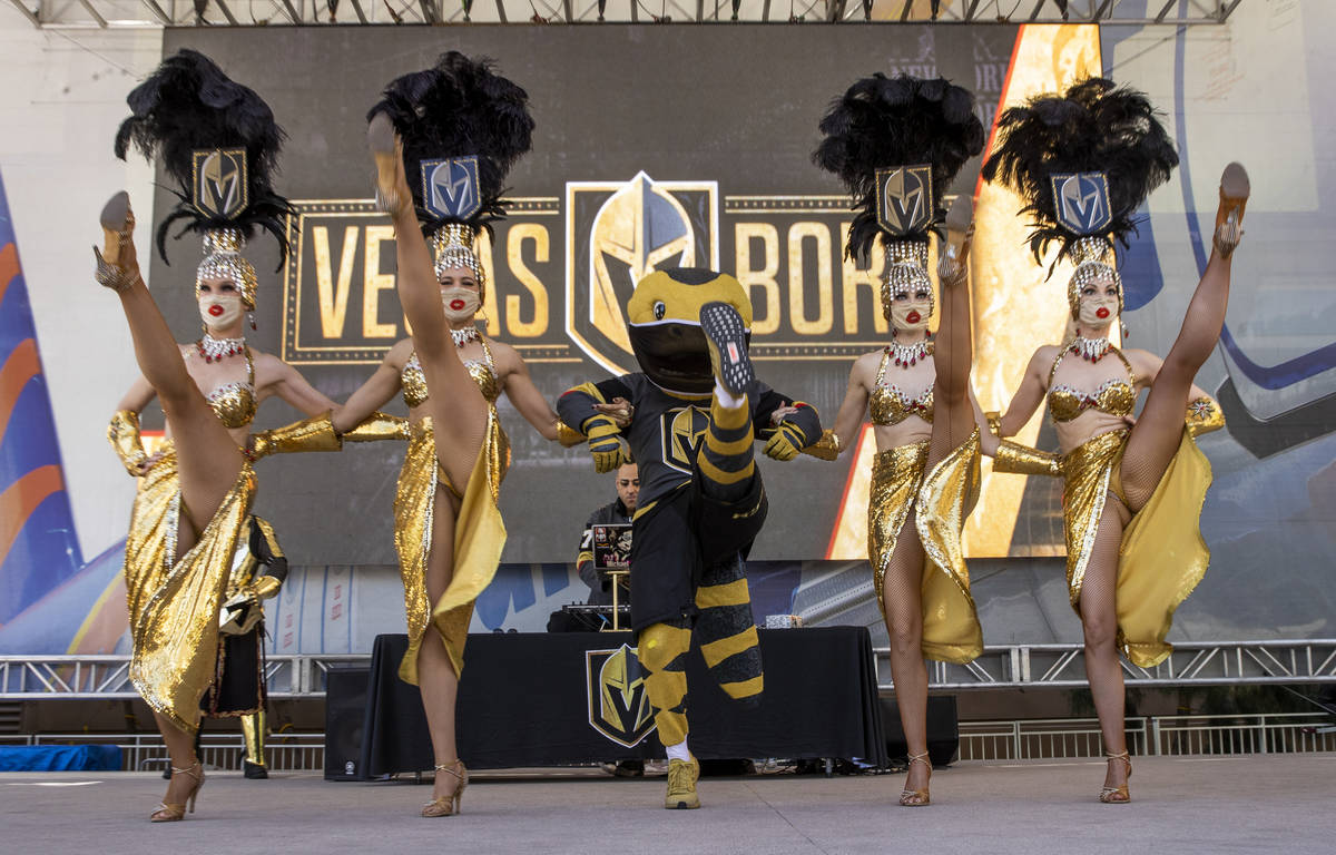 The Vegas Belles and Chance the Gila Monster dance outside before the first period of an NHL pl ...