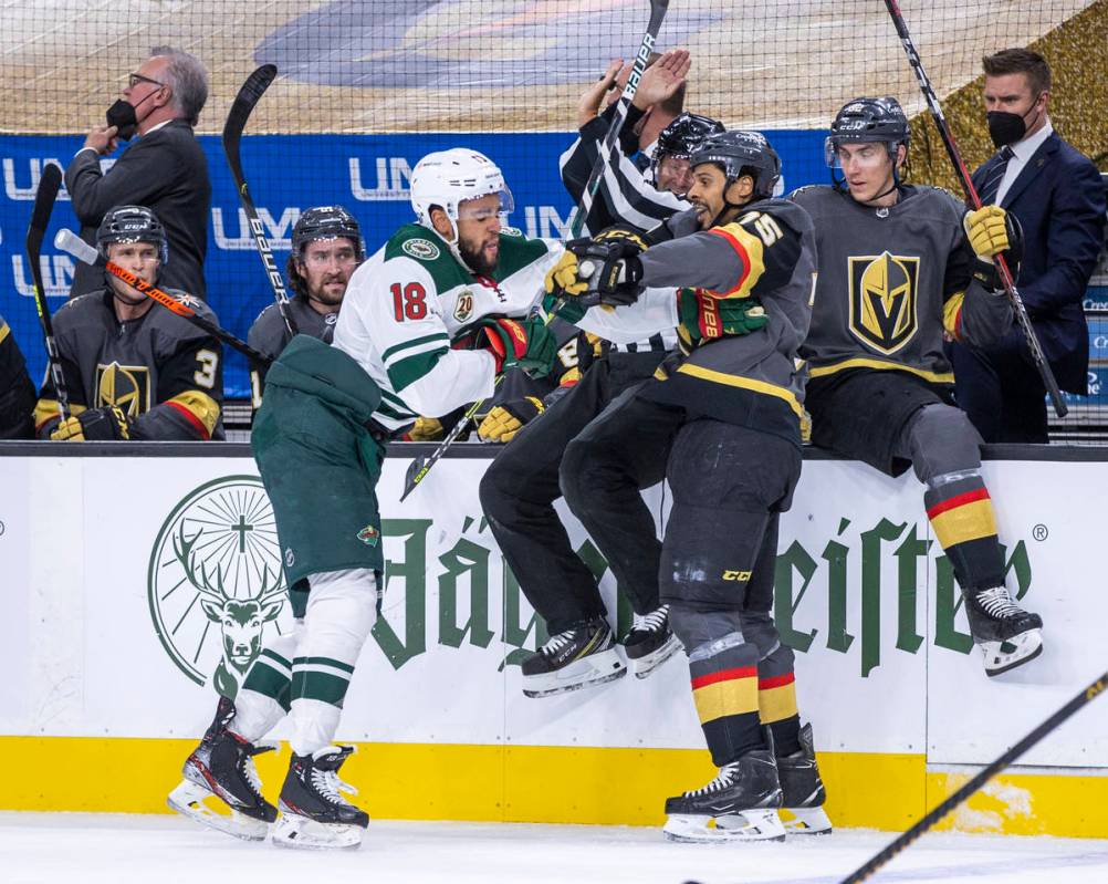 Golden Knights right wing Ryan Reaves (75) and Minnesota Wild left wing Jordan Greenway (18) ta ...