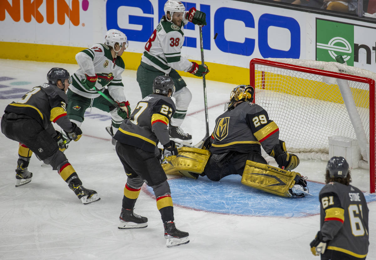 Golden Knights goaltender Marc-Andre Fleury (29) deflects a shot off his chest as Minnesota Wil ...