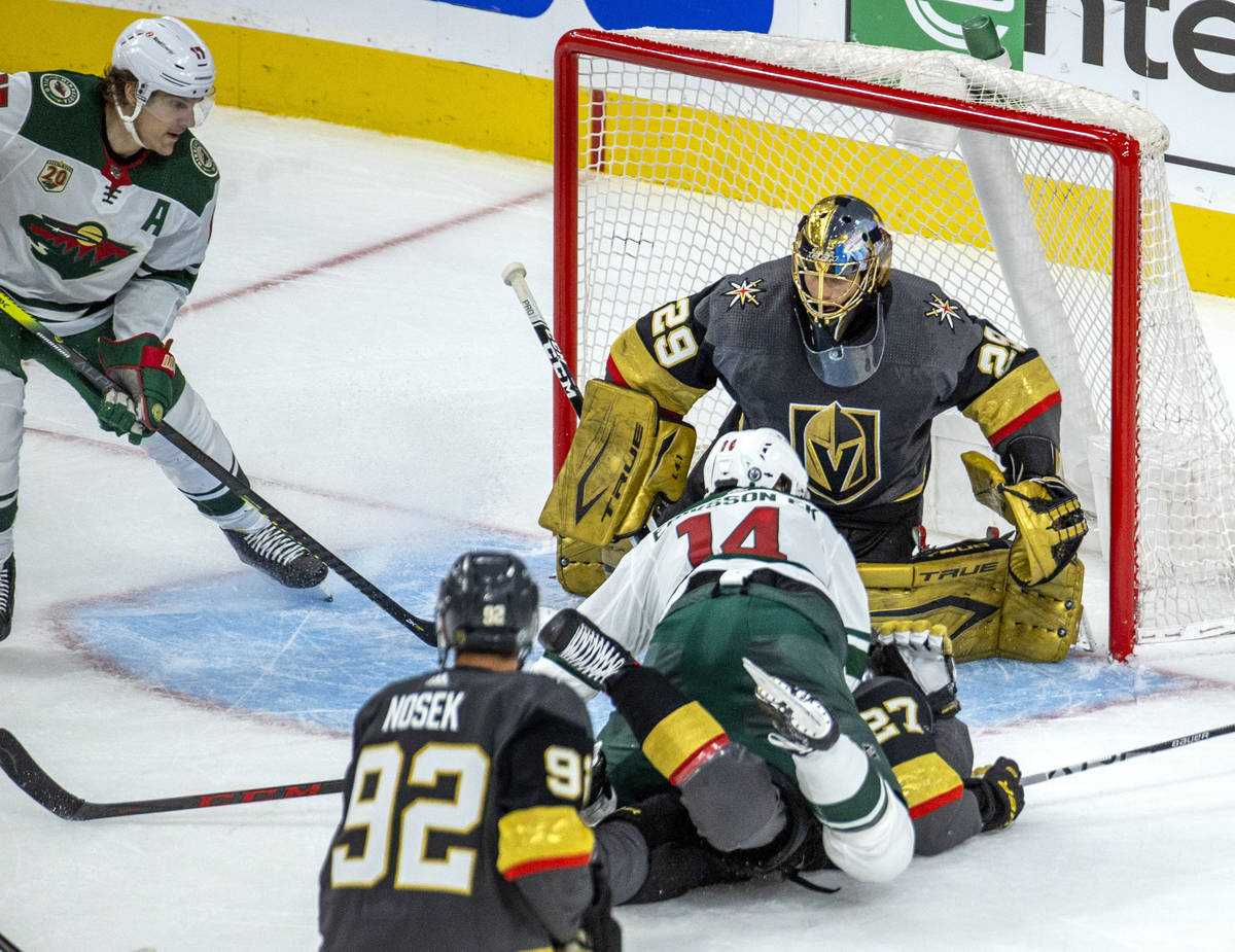 Golden Knights goaltender Marc-Andre Fleury (29) defends the net as Minnesota Wild center Joel ...