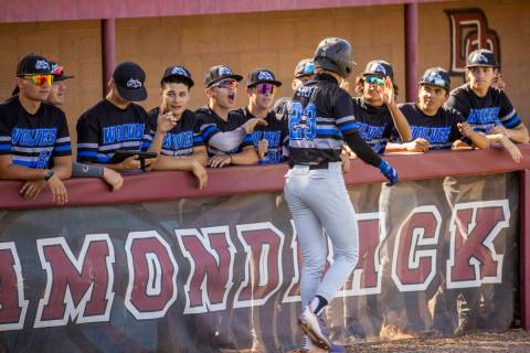Basic runner Cooper Sheff (23) helps celebrate a run with teammates against Basic High School d ...
