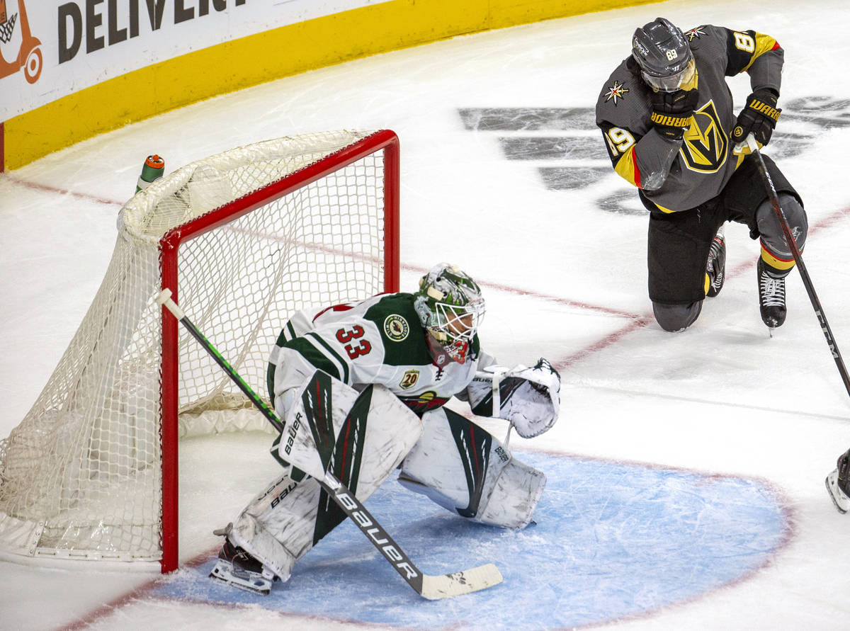 Minnesota Wild goaltender Cam Talbot (33) looks to defend as Golden Knights right wing Alex Tuc ...