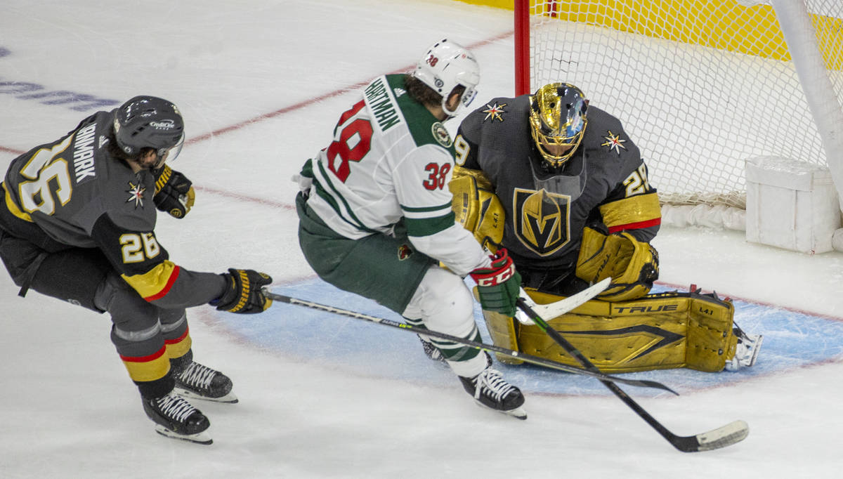 Golden Knights goaltender Marc-Andre Fleury (29) defends the net from Minnesota Wild right wing ...