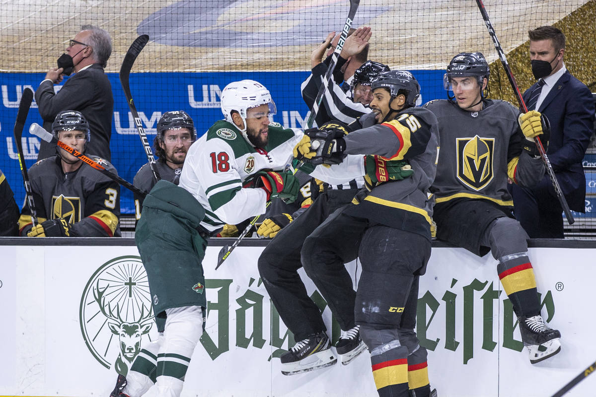 Golden Knights right wing Ryan Reaves (75) and Minnesota Wild left wing Jordan Greenway (18) ta ...