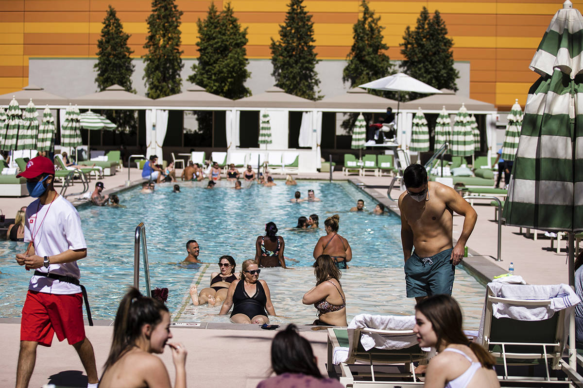 Guests lounge by the pool at Park MGM on Saturday, March 6, 2021, in Las Vegas. (Benjamin Hager ...