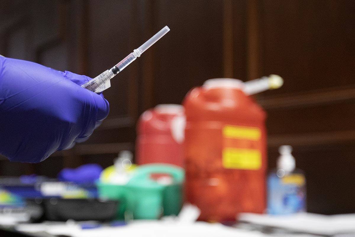 Chika McTier, a registered nurse, prepares a shot during a pop-up COVID-19 vaccine clinic at La ...