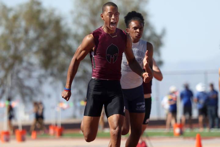 Cimarron-Memorial's Branden Smith wins the Boys 100 meter dash race followed by Canyon Spring's ...