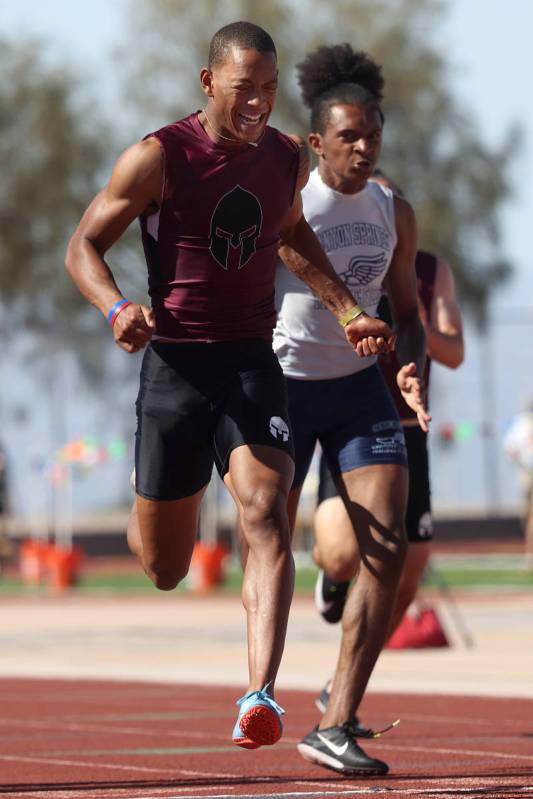 Cimarron-Memorial's Branden Smith wins the Boys 100 meter dash race followed by Canyon Spring's ...